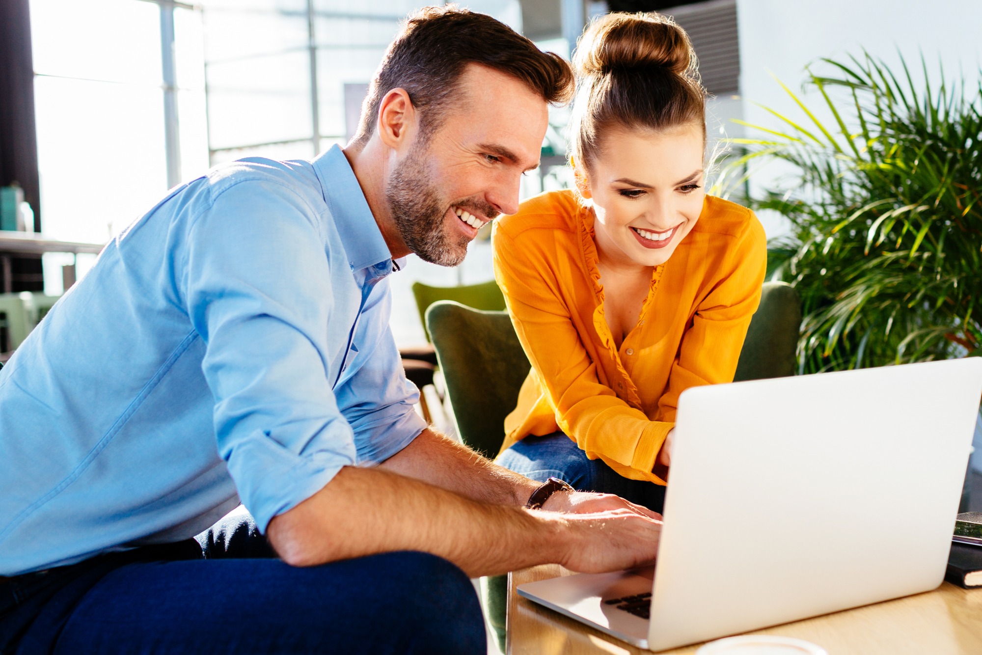 young attractive couple comparing sunshine coast home loans on laptop